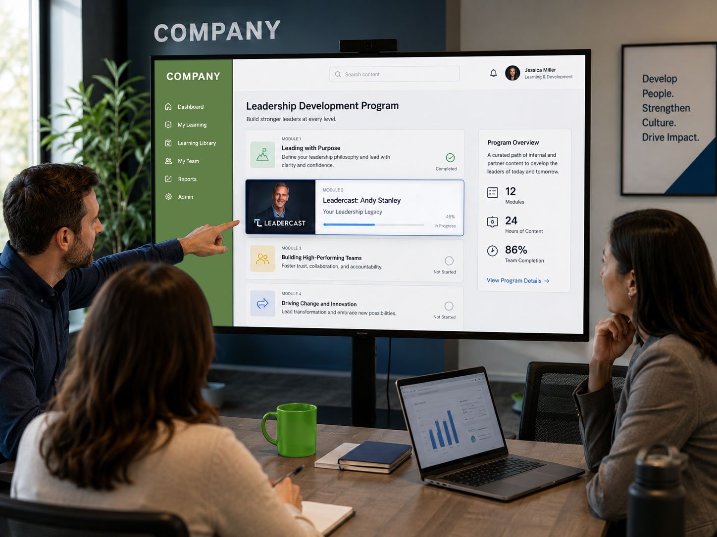 A team reviewing a leadership development program with Leadercast content on a large screen